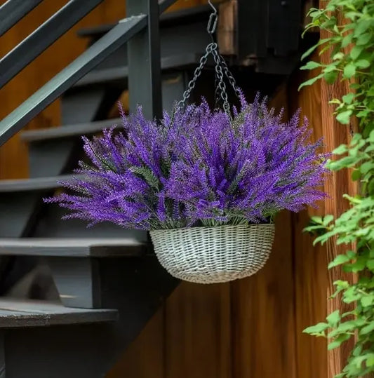 Artificial lavender bundles in white wicker hanging basket suspended from outdoor staircase railing, porch and patio décor