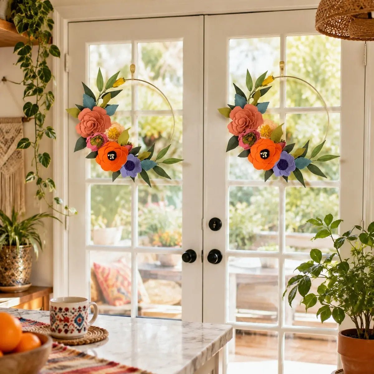 Colorful artificial flower hoop wreaths displayed on white French doors in boho home interior

