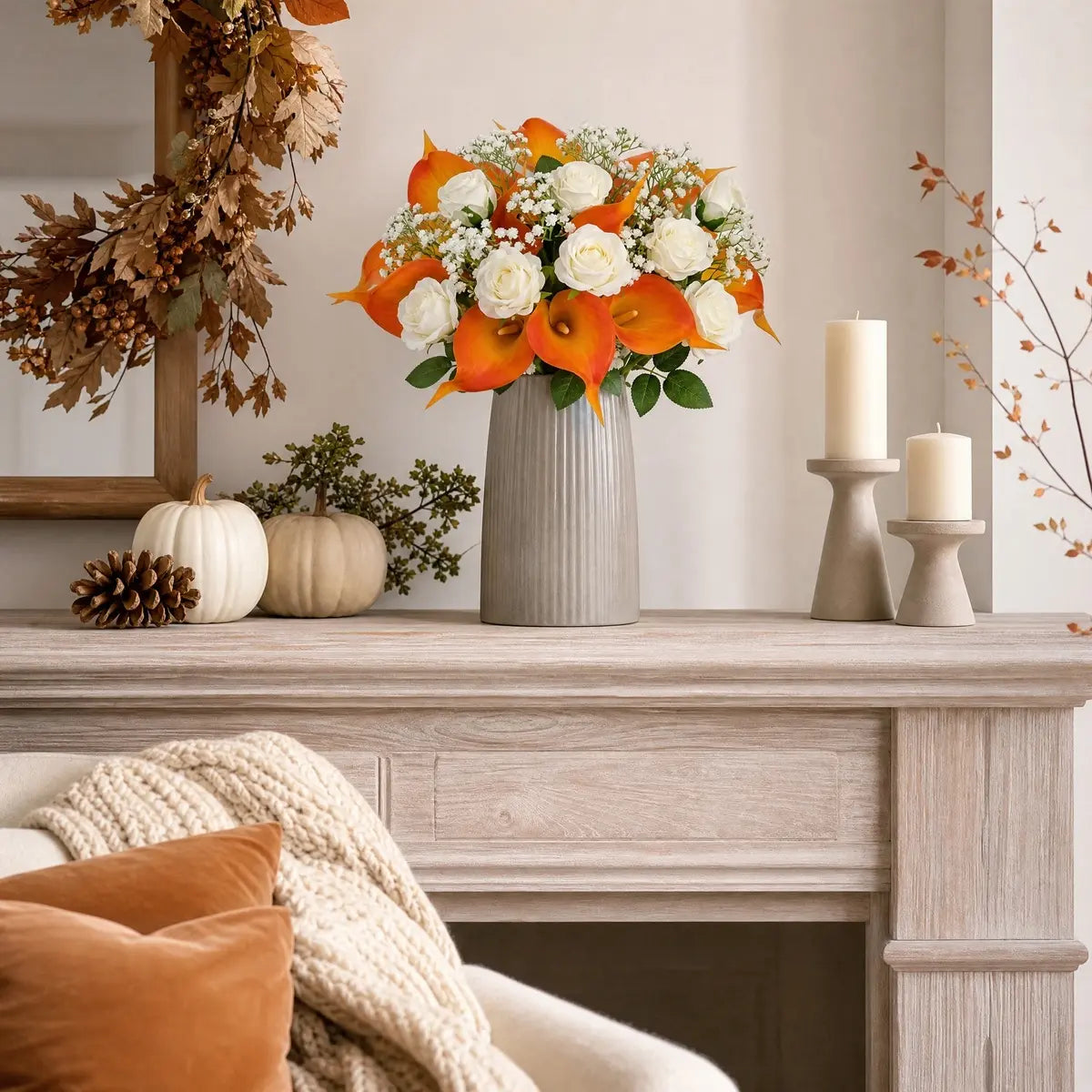 Close-up of orange calla lily and white rose stems in handmade autumn floral bouquet