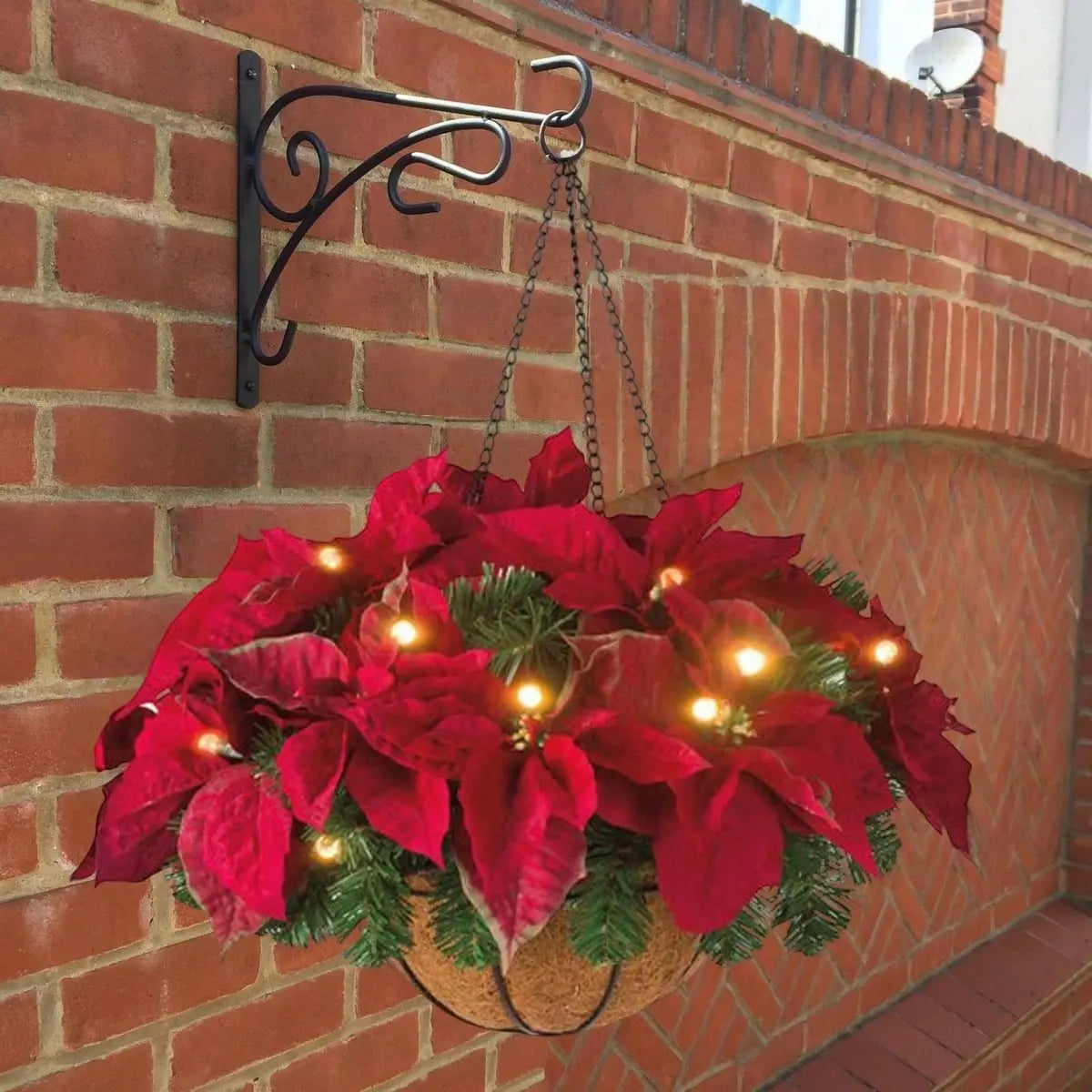 Pre-Lit Artificial Christmas Poinsettia Hanging Basket with LED Lights Mounted on Brick Wall
