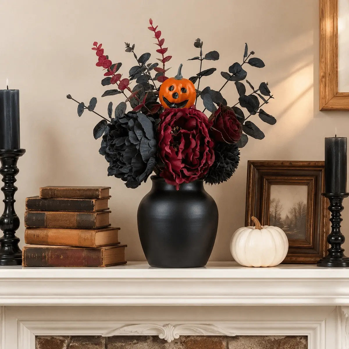 Gothic faux flower bouquet in black vase on fireplace mantel with dark candles and white pumpkin