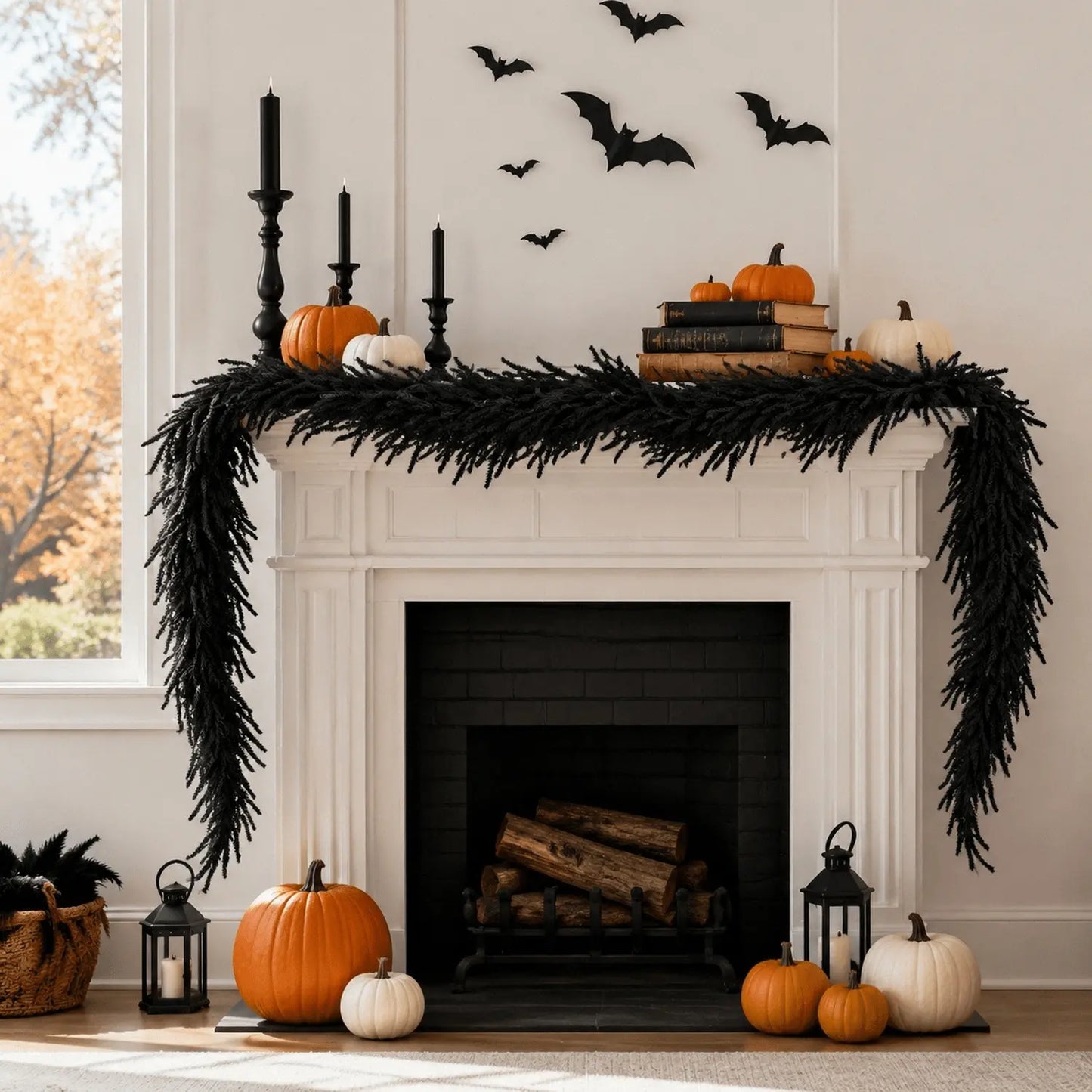 6ft black Halloween pine garland draped across a white fireplace mantel with black taper candles, orange and white pumpkins, stacked books and bat wall decals
