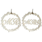 Close-up of Mr and Mrs wooden sign with rustic rope hanger for wedding