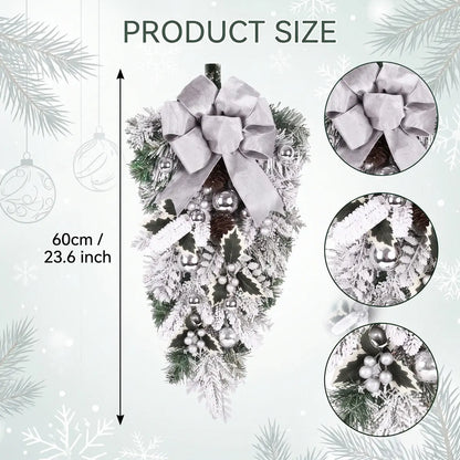 23.6 inch white Christmas teardrop swag with silver bow, silver ball ornaments, frosted pine branches, white berry clusters and holly leaves, product flat lay on white background
