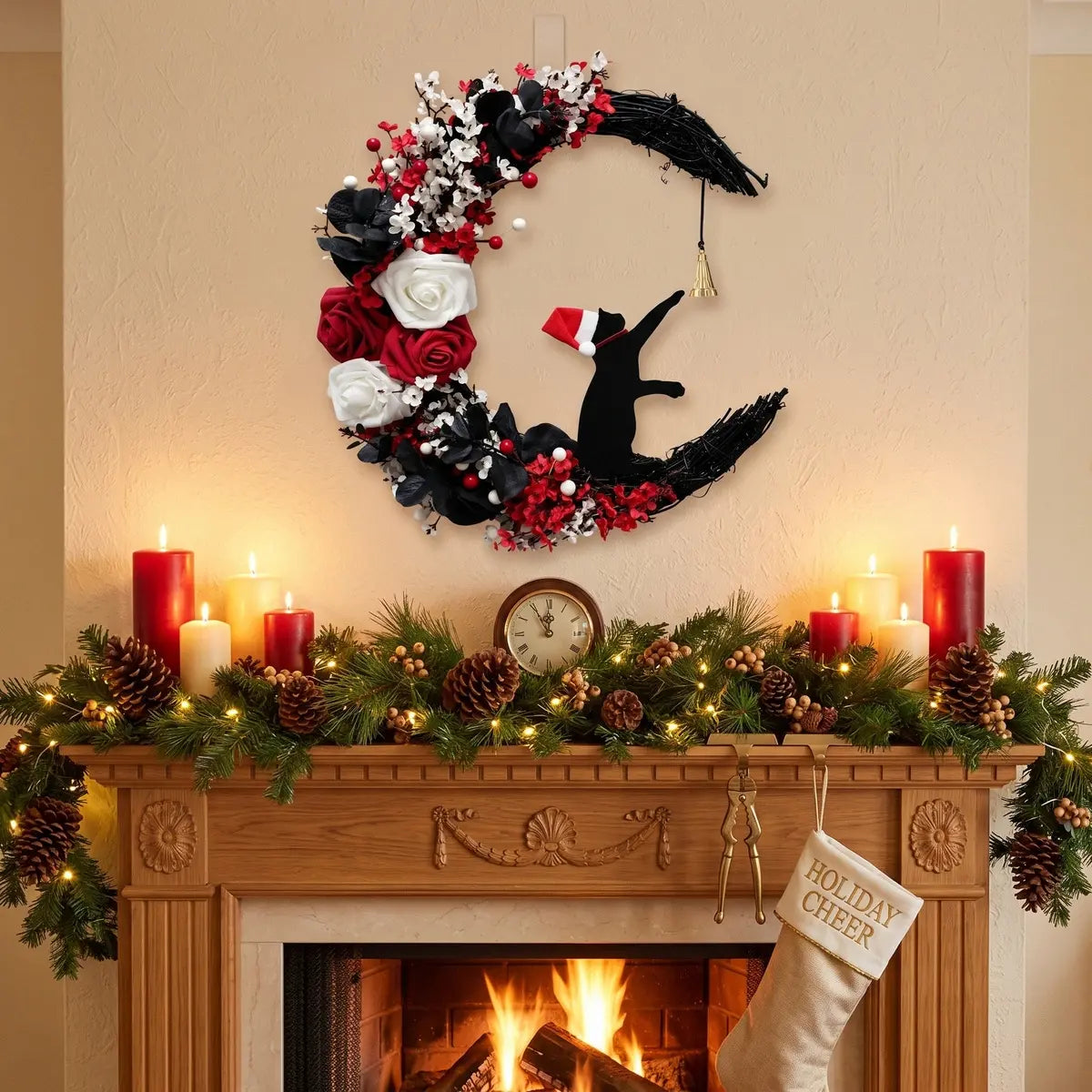 Christmas black cat moon wreath with white and red roses, red berries and gold jingle bell, hung above a lit fireplace mantel decorated with pine garland, pine cones, red pillar candles and Holiday Cheer stocking
