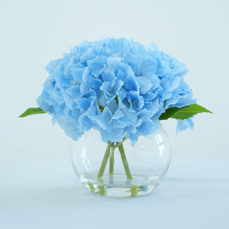 Blue artificial hydrangea flowers in glass vase for home dining table office decor centerpiece