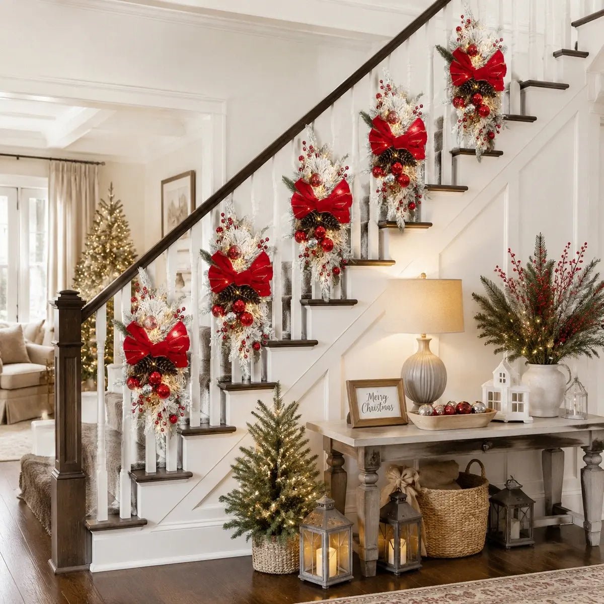 Christmas teardrop swag with red bow displayed on a staircase railing