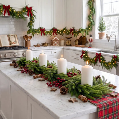 Four Norfolk pine candle ring wreaths arranged as a kitchen island centerpiece with white pillar candles, red berries, pine cones and cinnamon sticks, in a fully decorated Christmas farmhouse kitchen
