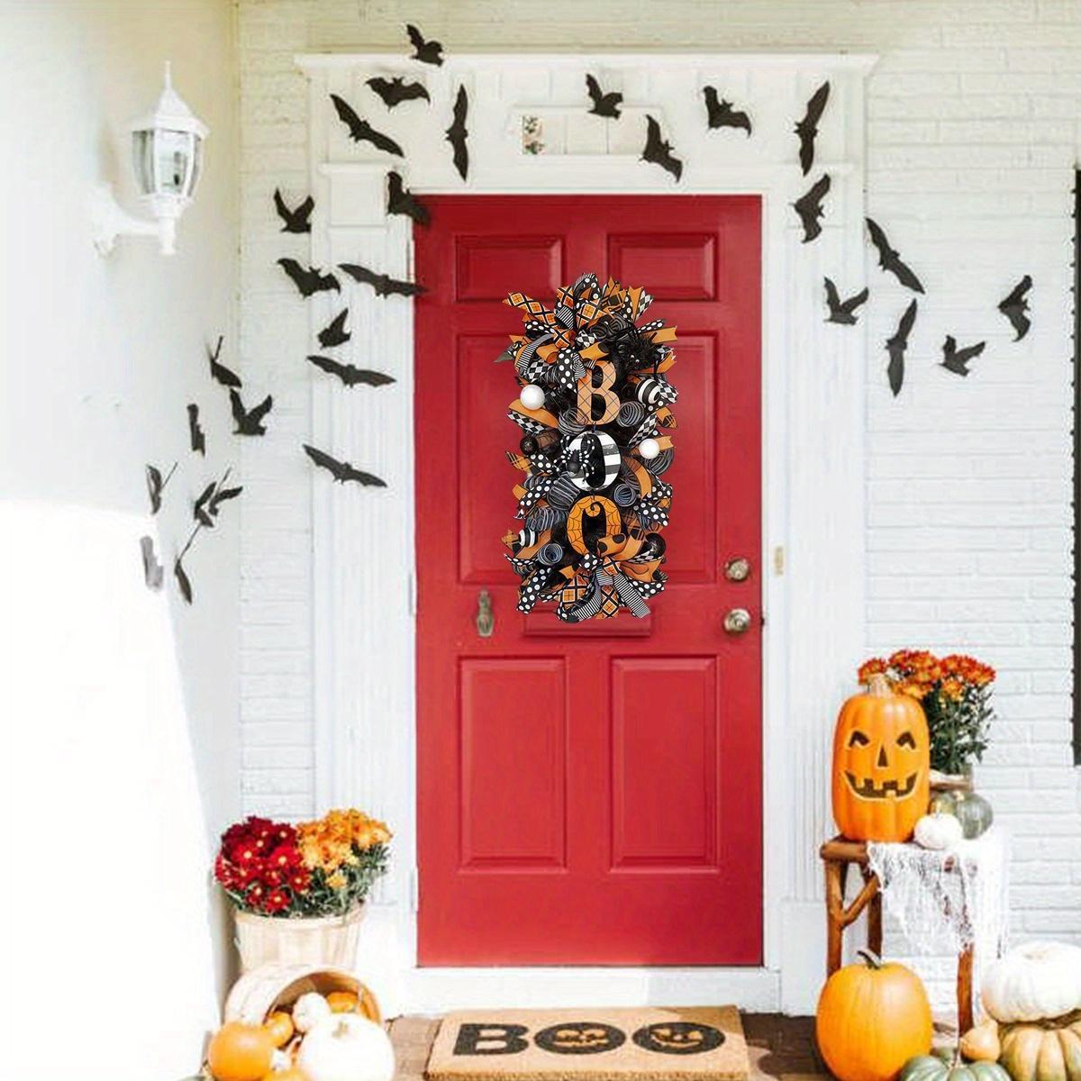 Close-up of skull and pumpkin details on Halloween front door wreath