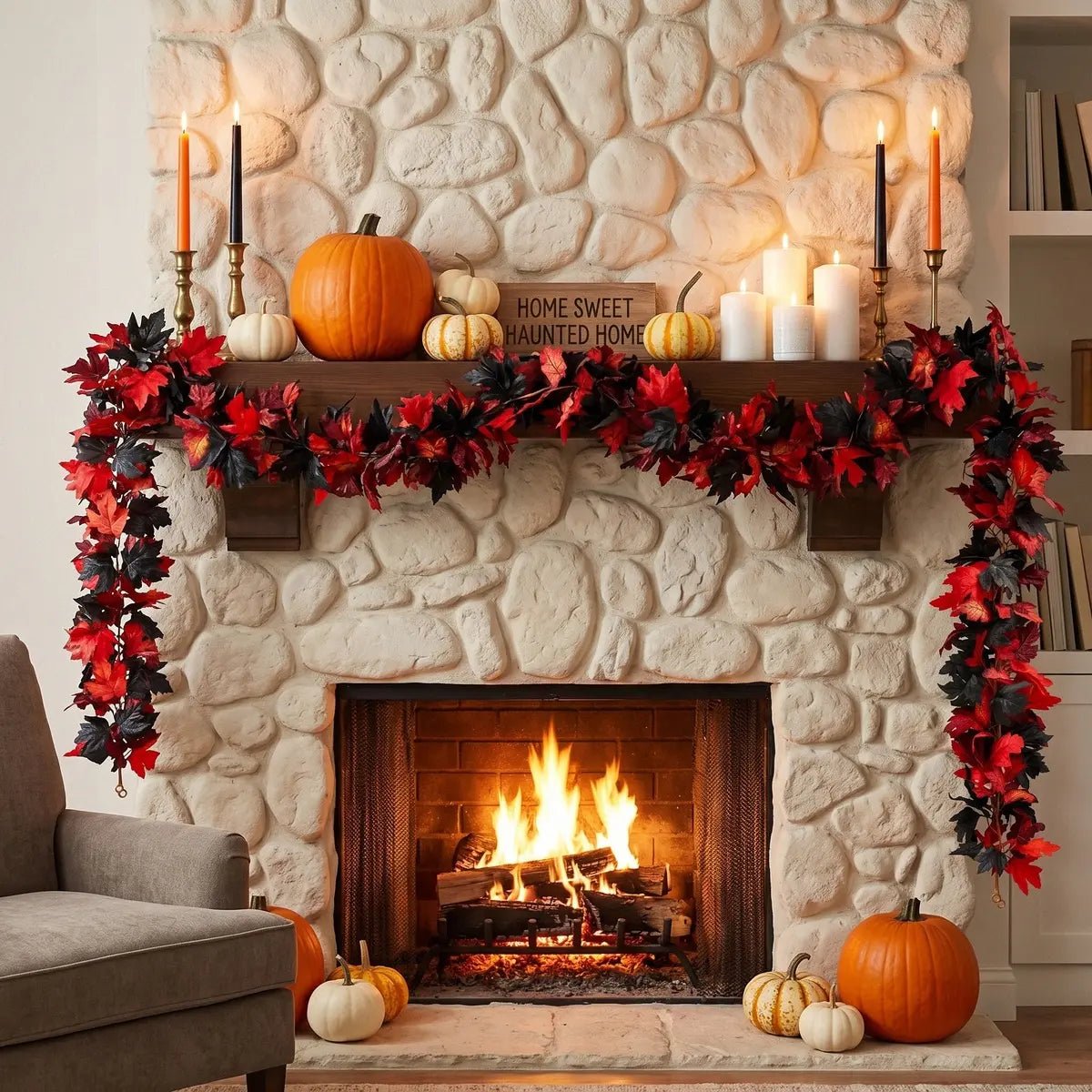 2pcs red and black maple leaf fall garland draped across a stone fireplace mantel and down both sides with orange and white pumpkins, black and orange taper candles, and a Home Sweet Haunted Home sign for Halloween home decor