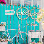 Rustic wooden hanging signs for bride and groom chairs at wedding reception