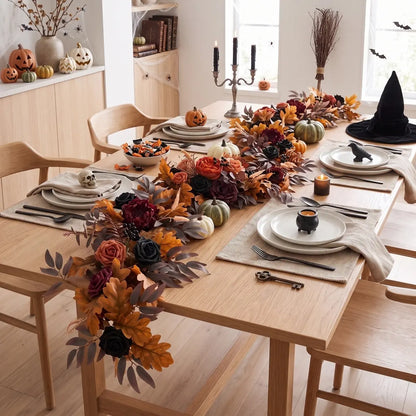Faux eucalyptus floral garland used as autumn table runner for fall wedding or Thanksgiving tablescape