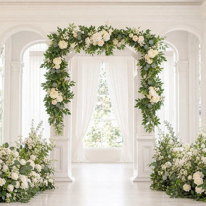 Artificial white rose eucalyptus garland draped on white square wedding arch in bright indoor ceremony hall with arched windows – IPOPU
