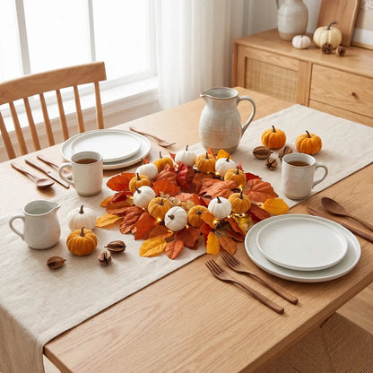 Harvest fall wreath with pumpkins and autumn foliage styled as a table centerpiece for Thanksgiving dining decor
