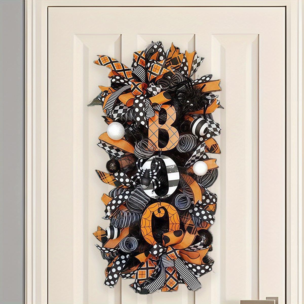 Halloween wreath with sign hanging on front door for spooky porch decor