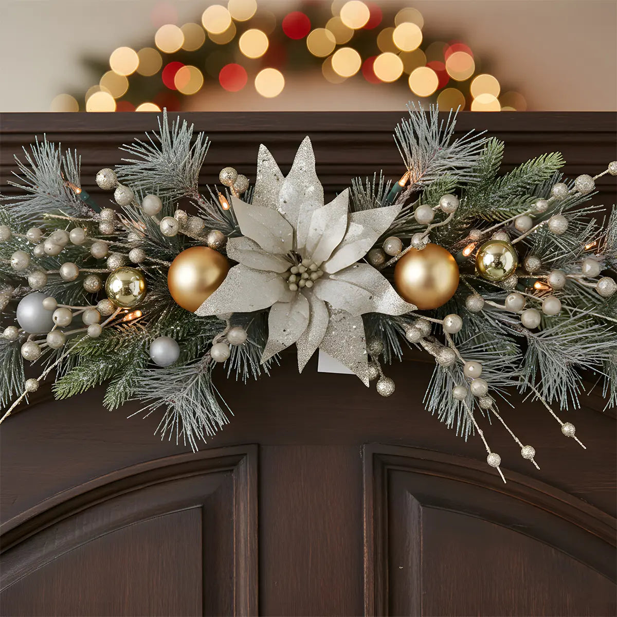 Close-Up of Artificial Christmas Poinsettia Door Swag with Gold Ball Ornaments and Pine Branches
