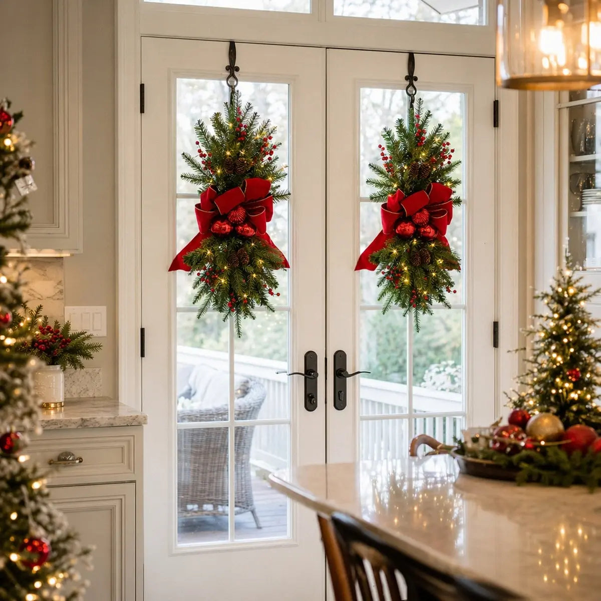 Artificial Christmas swag wreath with red bow and pine cones hanging on a front door entryway
