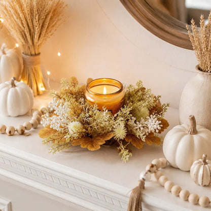 Neutral fall candle ring wreaths with golden maple leaves and cream berries arranged around candles on a console table with mirror
