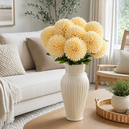 Yellow ball chrysanthemum artificial flower stems in tall white vase on living room coffee table, modern farmhouse home décor