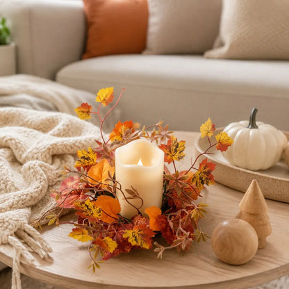 Fall maple leaf candle ring wreaths with autumn foliage displayed around candles on a living room side table with seasonal home decor