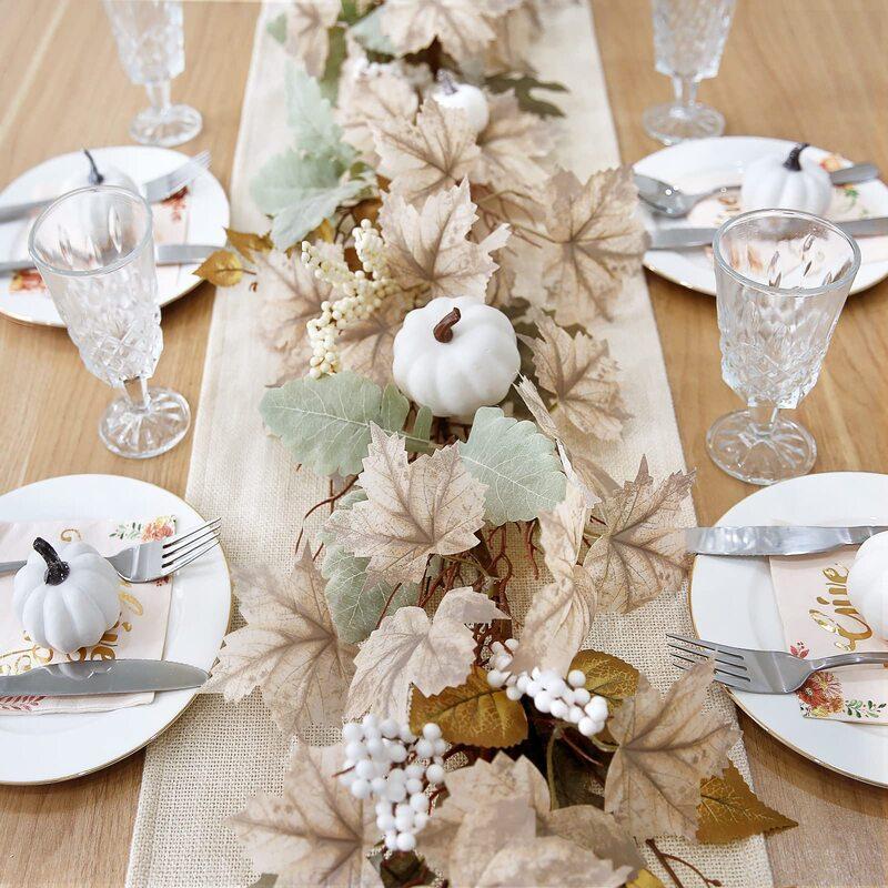Artificial fall garland close-up – maple leaves pumpkins berries for mantel decor