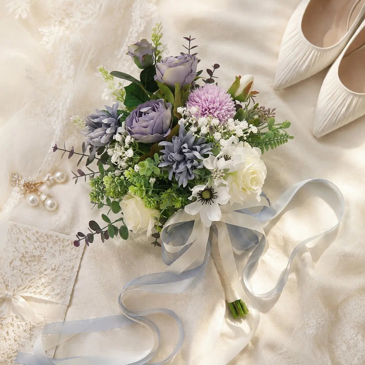 Artificial dusty purple rose white anemone bridal bouquet with satin ribbon flat lay on wedding dress with pearl earrings and heels – IPOPU
