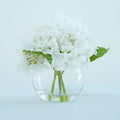 White artificial hydrangea flowers in glass vase for home dining table office decor centerpiece