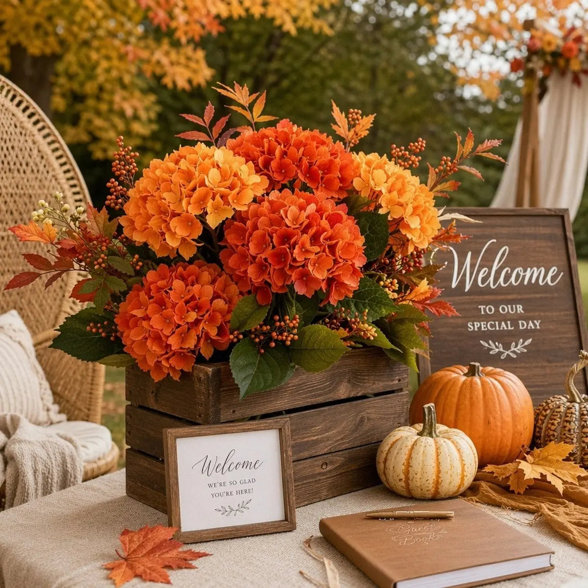 rtificial orange hydrangea stems arranged in a glass vase with greenery for a Thanksgiving harvest table centerpiece