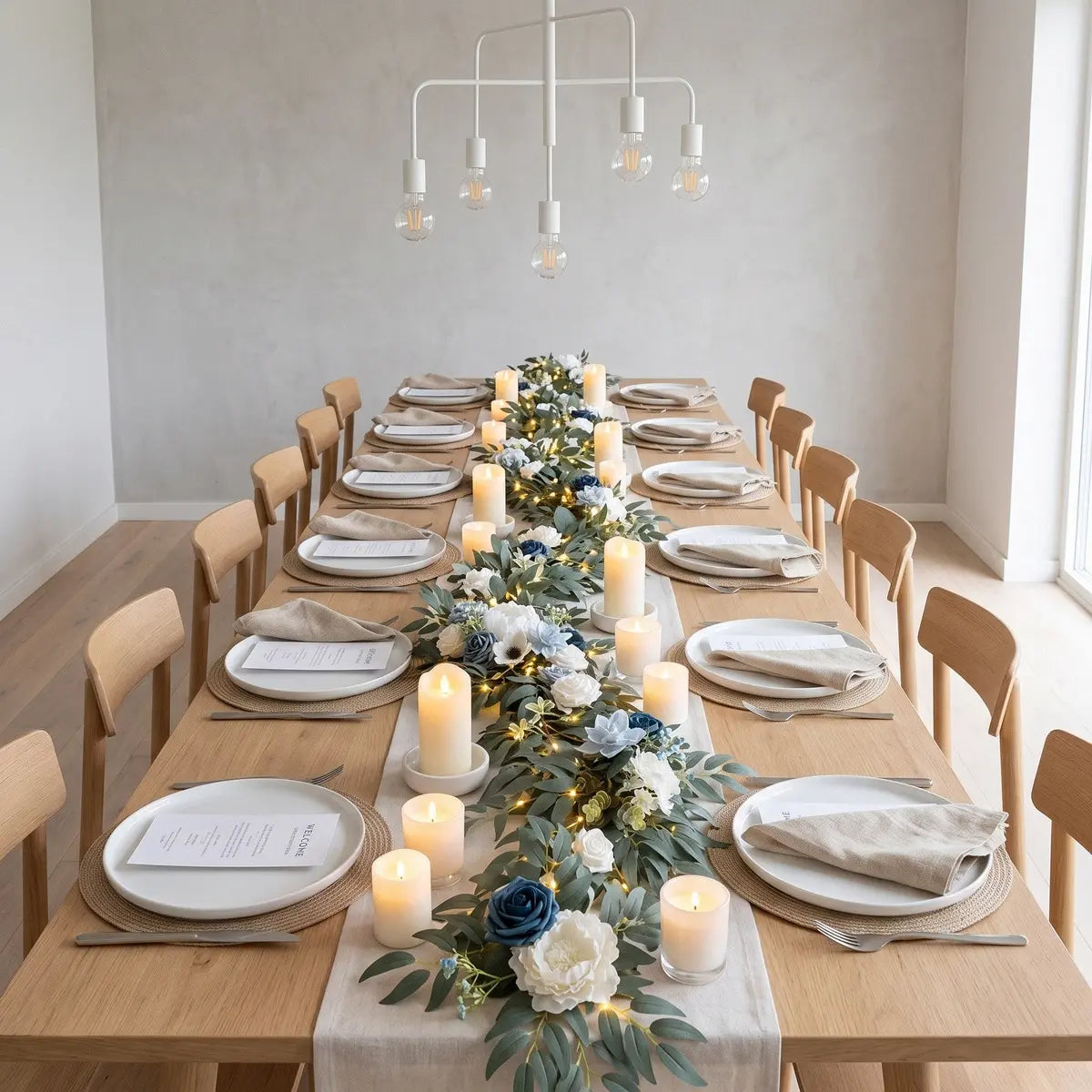 Artificial dusty blue navy white rose eucalyptus garland with LED lights as table runner on long wood dining table with pillar candles and place settings – IPOPU