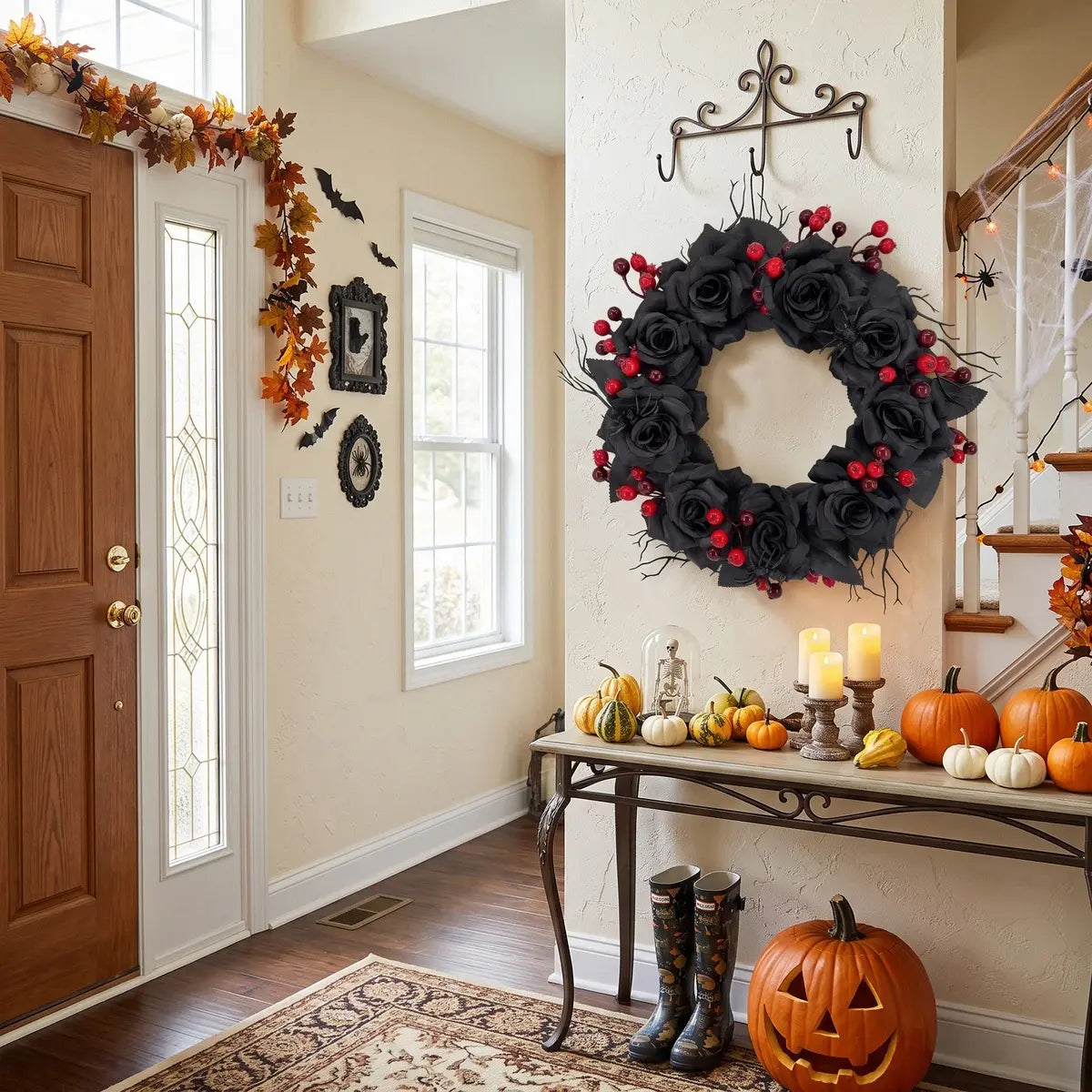 15.7'' black rose gothic Halloween wreath with red berries hung on a wall in a Halloween decorated entryway with pumpkins
