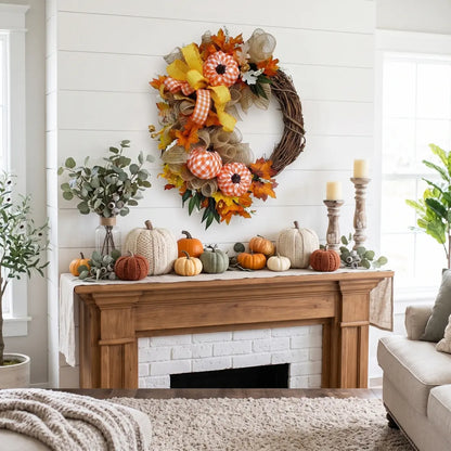 Autumn grapevine pumpkin wreath displayed above farmhouse fireplace mantel decorated with pumpkins and candles in white shiplap living room
