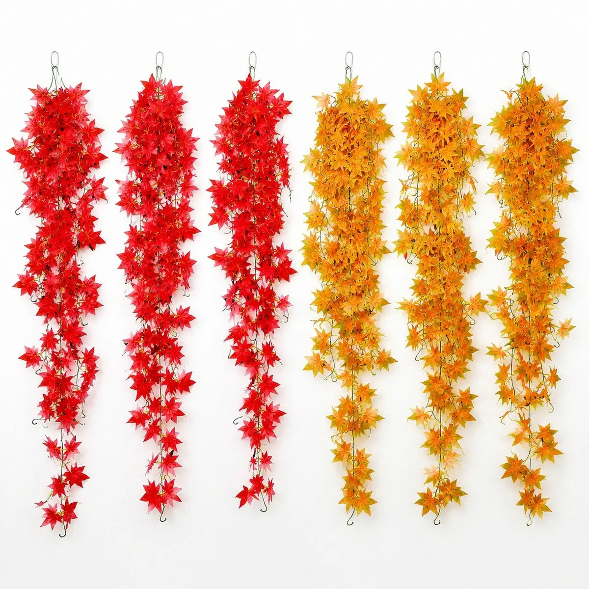 Set of 6 artificial fall maple leaf hanging vines, 3 red and 3 yellow, displayed on white background with hooks