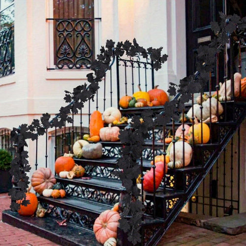 Black maple leaf garland vine draped on staircase for Halloween gothic decor