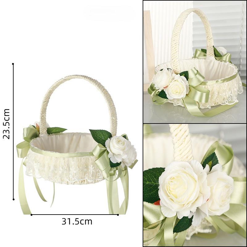 White handwoven wicker wedding flower girl basket with pearl handle and ribbon bow for rustic boho ceremony
