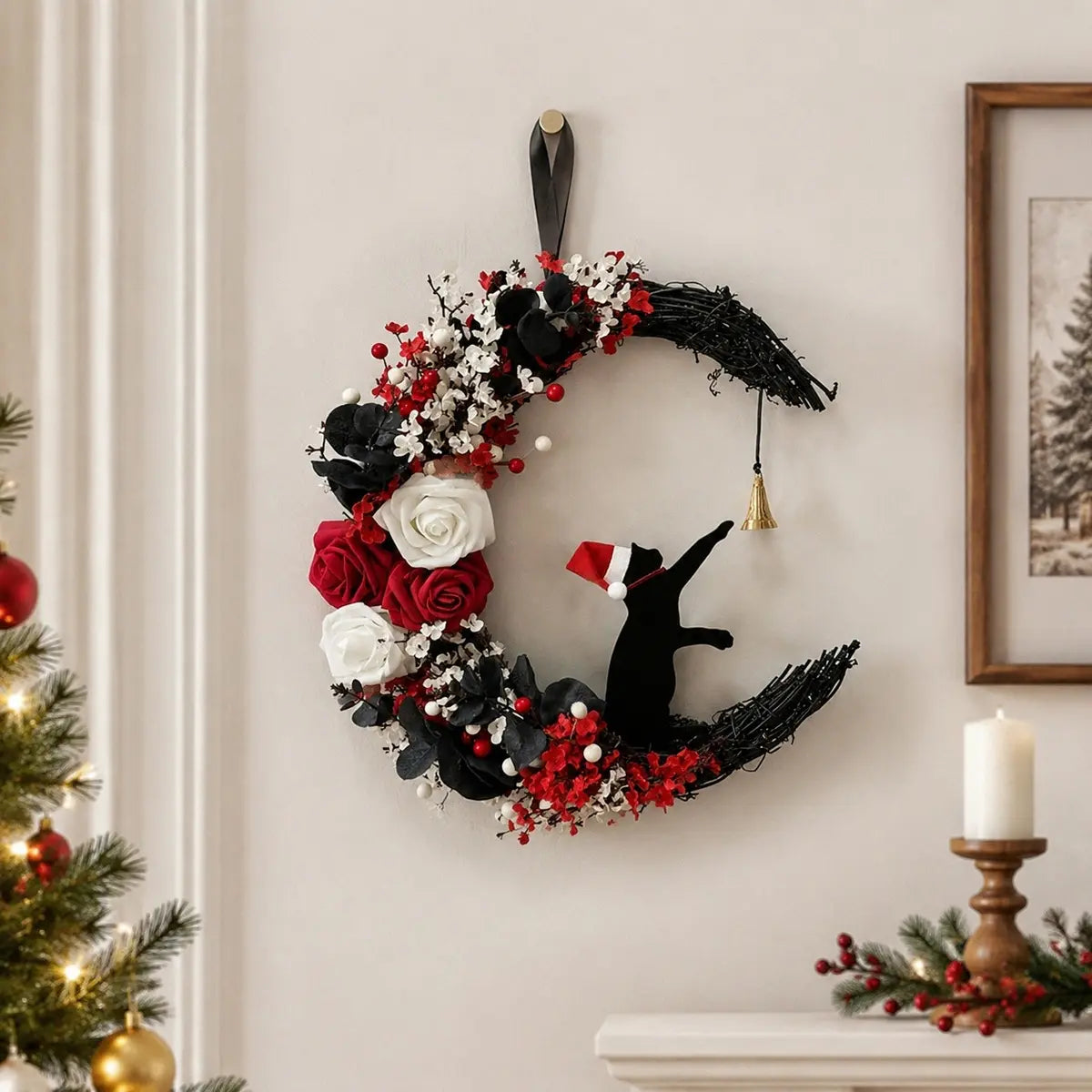 Christmas black cat moon wreath with white and red roses, red berries and gold jingle bell, hung on white wainscoting wall above a dark console table styled with wrapped Christmas gifts, lantern and holiday stockings
