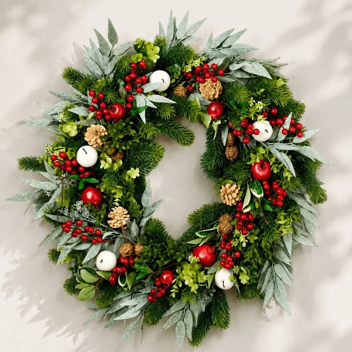 Artificial Christmas wreath with mixed greenery, berries and pinecones