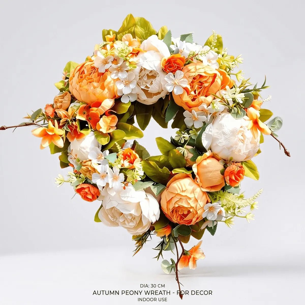Orange and white silk peony wreath hung on a white front door for fall autumn Thanksgiving home decor