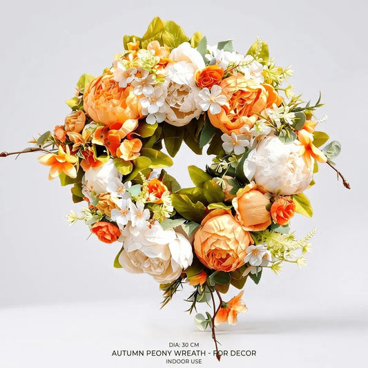 Orange and white silk peony wreath hung on a white front door for fall autumn Thanksgiving home decor