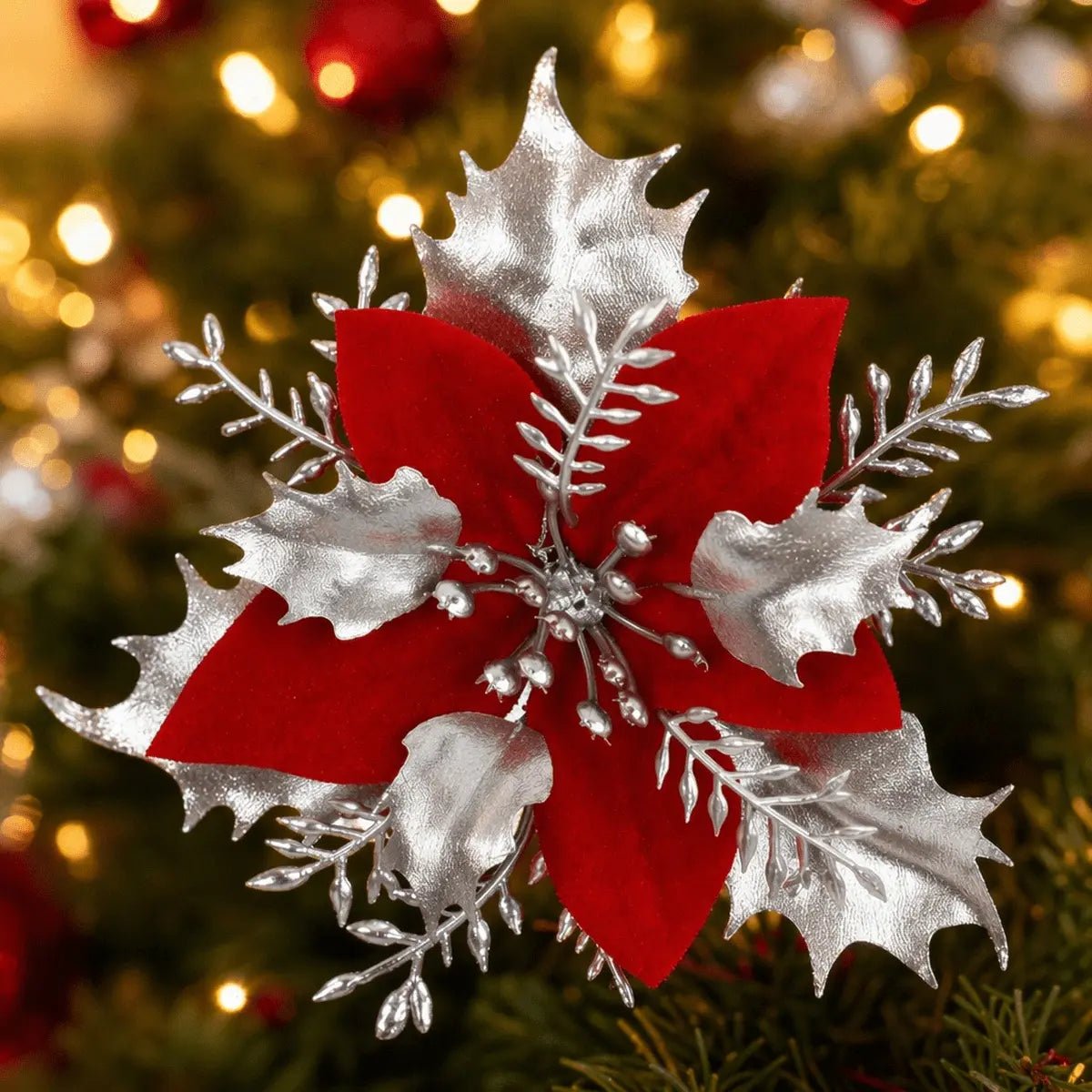 Red and silver poinsettia pick displayed on a Christmas tree