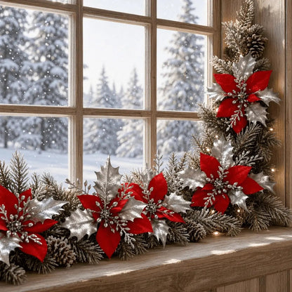 Red poinsettia picks decorating a snowy window garland