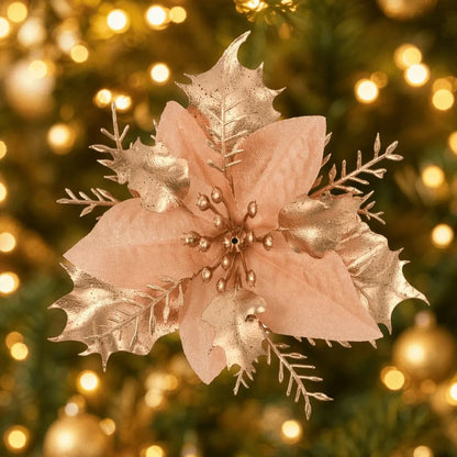 Gold poinsettia pick displayed on a lit Christmas tree