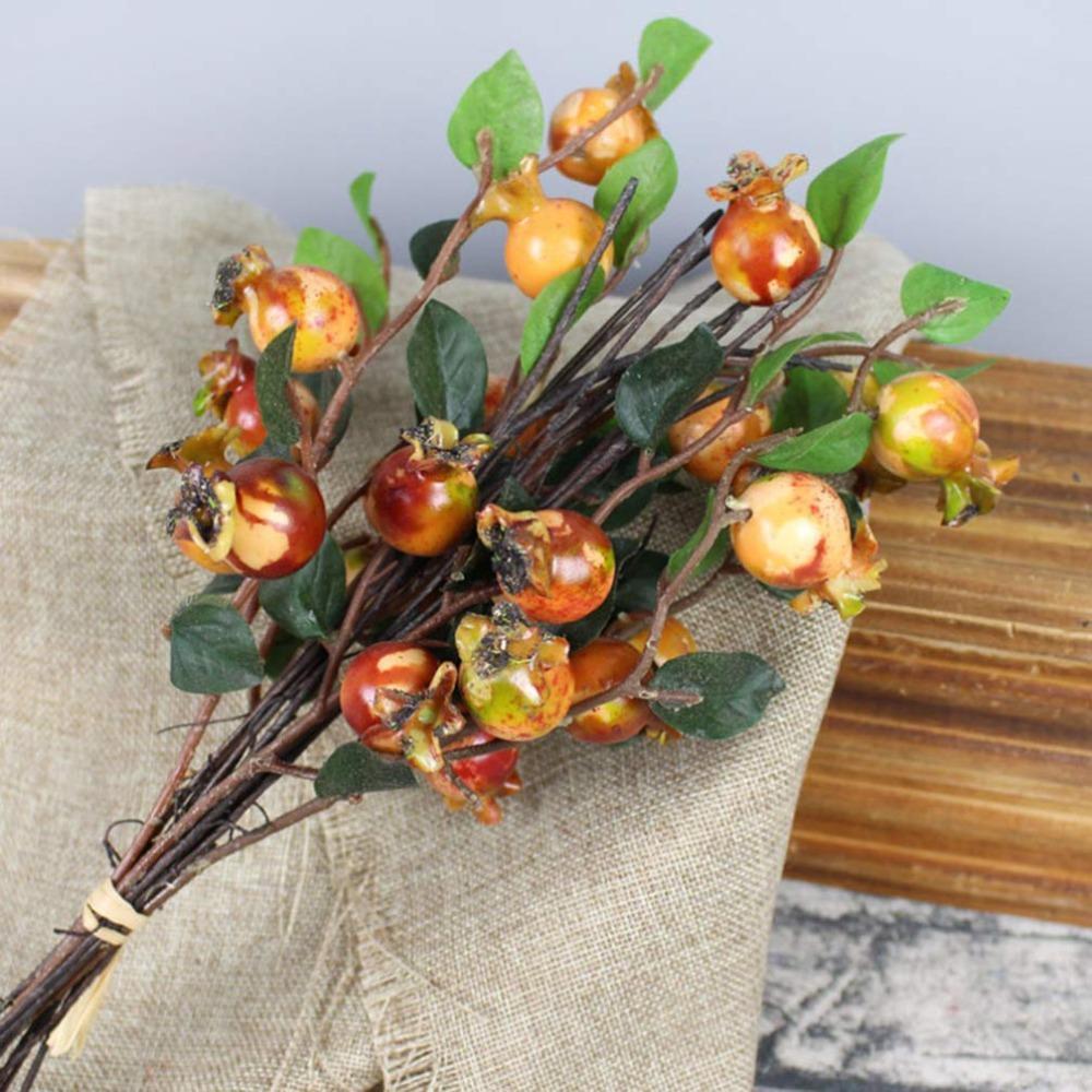 Rosehip berries and simulation pomegranate fruit arranged for wreath centerpiece by IPOPU