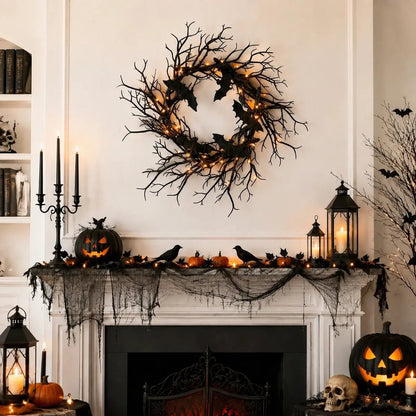 Gothic black bat wreath styled on window frame with Halloween seasonal decor and candles