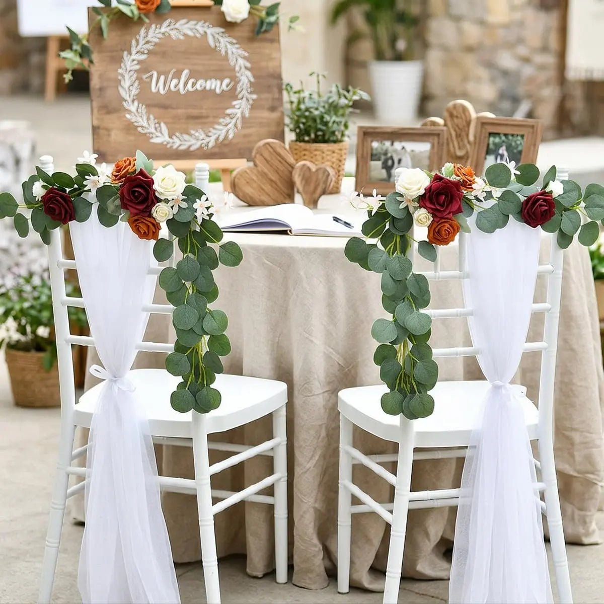Artificial rose eucalyptus garland on sweetheart chairs at outdoor wedding sign-in table with Welcome sign – IPOPU

