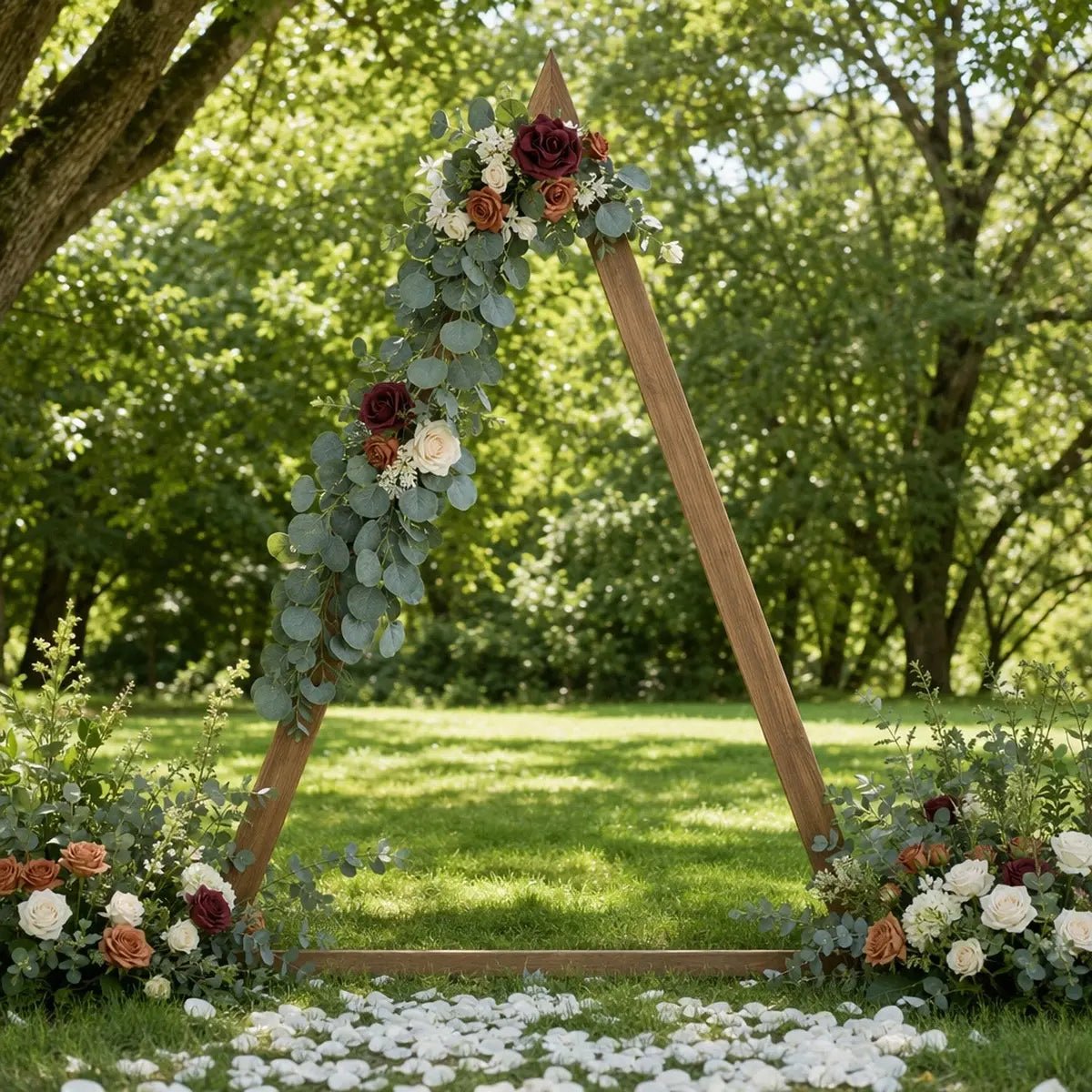 Burgundy terracotta rose silver dollar eucalyptus swag set of 2 attached to rustic wood triangle wedding arch apex and left mid-post at outdoor garden ceremony with white petal aisle – IPOPU