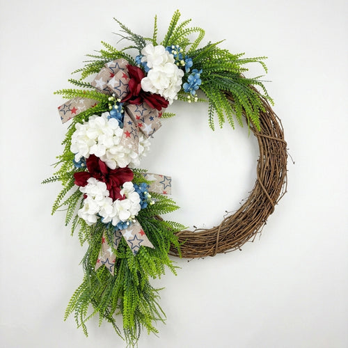 Patriotic red white and blue wreath with burlap bow white hydrangeas and blue berries for front door porch and home wall decor for 4th of July and Memorial Day