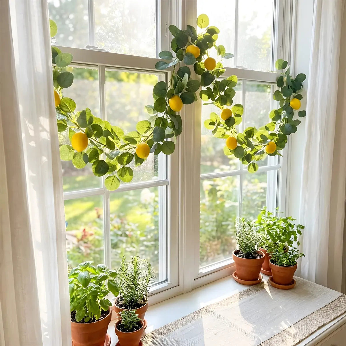 Artificial lemon greenery garland with eucalyptus leaves draped across rustic farmhouse dining table as centerpiece, with croissants, lemon bowl and lantern, kitchen home décor
