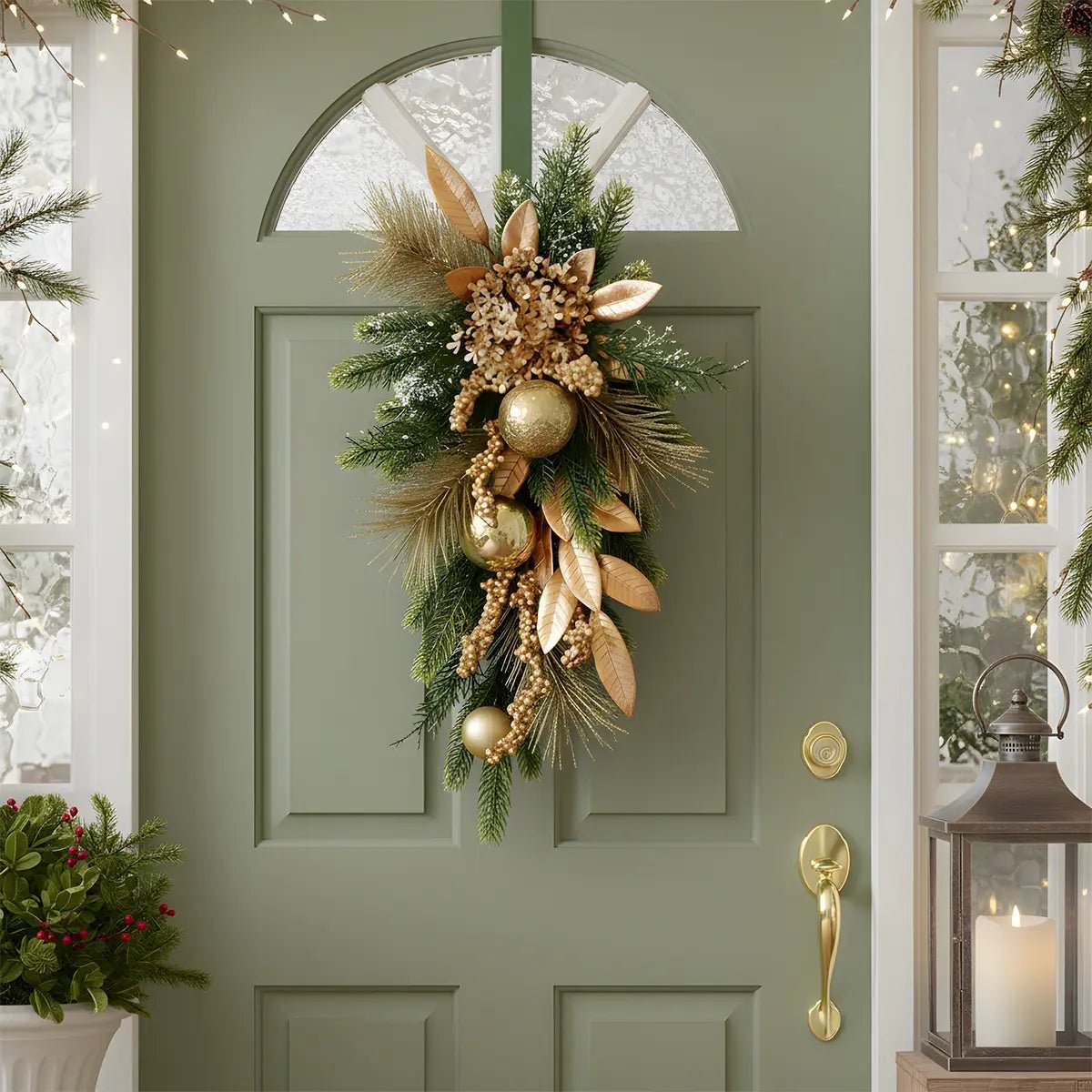 Christmas teardrop swag wreath with hydrangea and gold ornaments hanging on green front door
