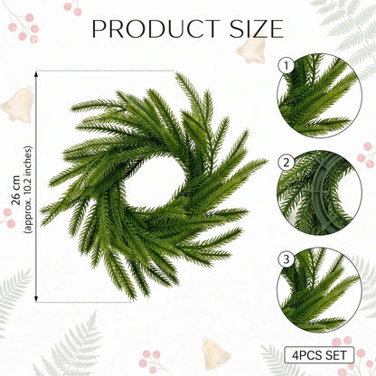 Norfolk pine candle ring wreath product size chart showing 26cm (10.2 inch) diameter, 4-piece set, with close-up details of realistic pine needle texture and green plastic base frame
