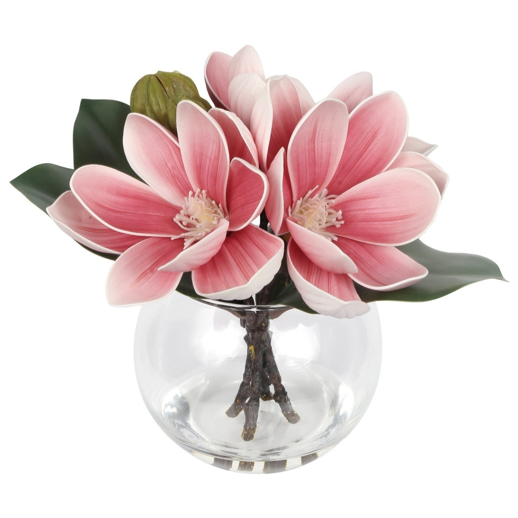 Pink artificial magnolia flowers in glass vase with faux water for home bathroom office decor
